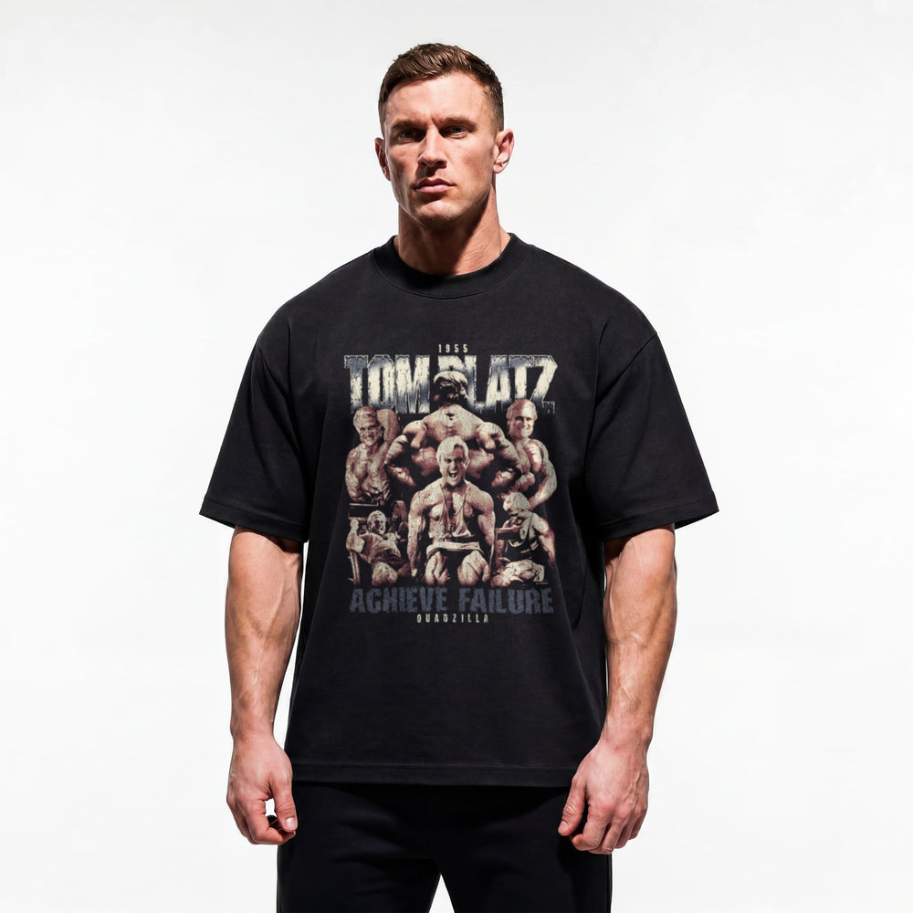 Model wearing Most Natty Achieve Failure Tom Platz bodybuilding oversized t-shirt showing relaxed drop-shoulder fit