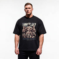Model wearing Most Natty Achieve Failure Tom Platz bodybuilding oversized t-shirt showing relaxed drop-shoulder fit