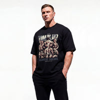 Model wearing Most Natty Achieve Failure Tom Platz bodybuilding oversized t-shirt showing front graphic print