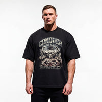 Model wearing Most Natty Conquer bodybuilding oversized t-shirt showing relaxed drop-shoulder fit