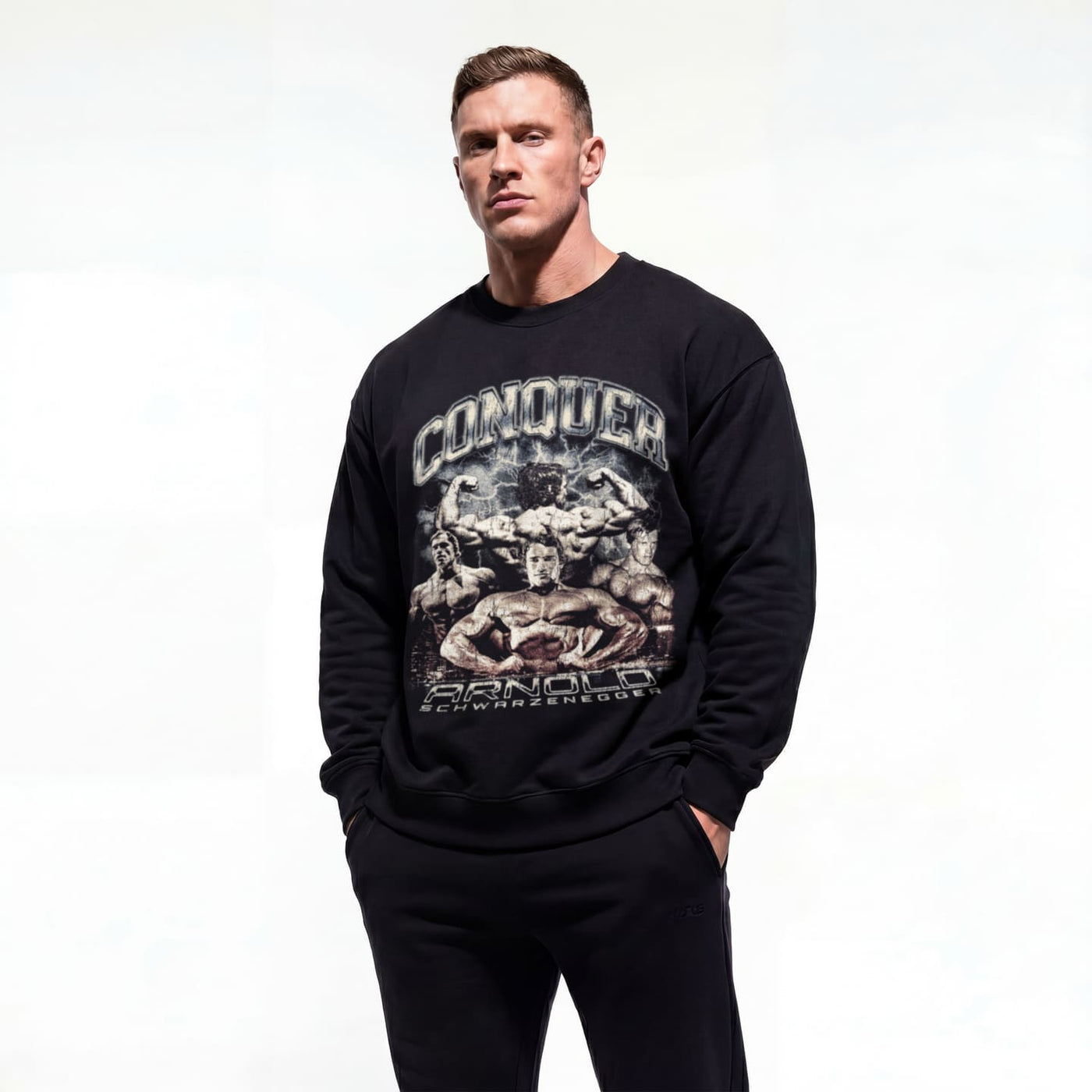 Model wearing Arnold Schwarzenegger Conquer bodybuilding pump cover crewneck showing front graphic print