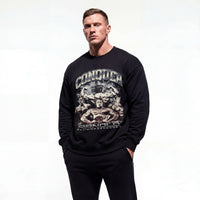 Model wearing Arnold Schwarzenegger Conquer bodybuilding pump cover crewneck showing front graphic print