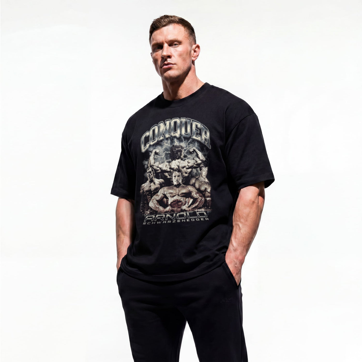 Model wearing Most Natty Conquer bodybuilding oversized t-shirt showing front graphic print