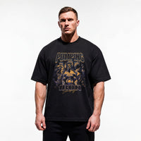 Model wearing Most Natty Pumping Iron bodybuilding oversized t-shirt showing relaxed drop-shoulder fit