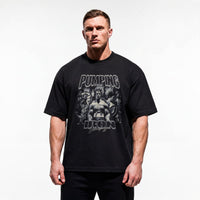 Model wearing Most Natty Pumping Iron bodybuilding oversized t-shirt showing relaxed drop-shoulder fit