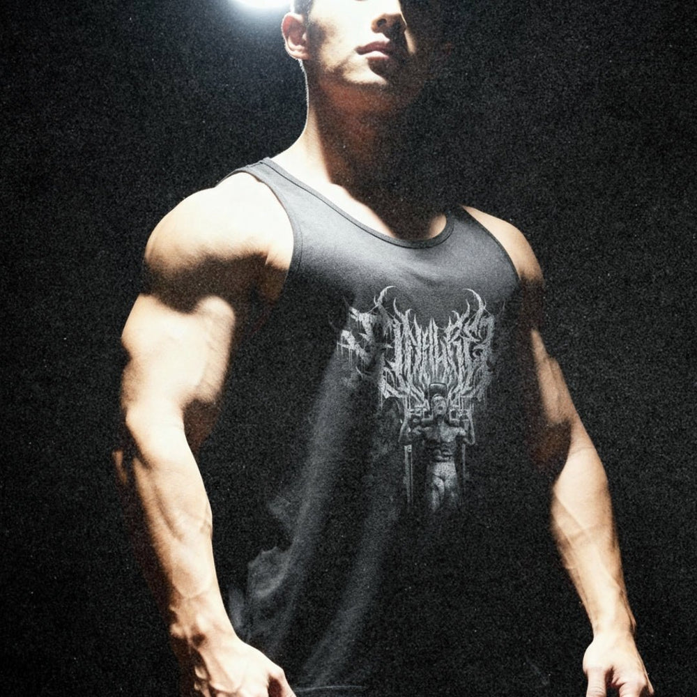 Model wearing Most Natty Final Rep bodybuilding tank top showing relaxed standard fit in moody setting