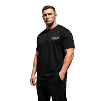 Model wearing Most Natty LAT Club bodybuilding t-shirt showing relaxed classic fit