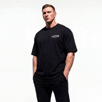 Model wearing Most Natty LAT Club bodybuilding oversized t-shirt showing front graphic print