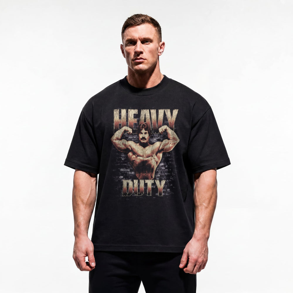 Model wearing Mike Mentzer Heavy Duty bodybuilding oversized t-shirt showing relaxed drop-shoulder fit