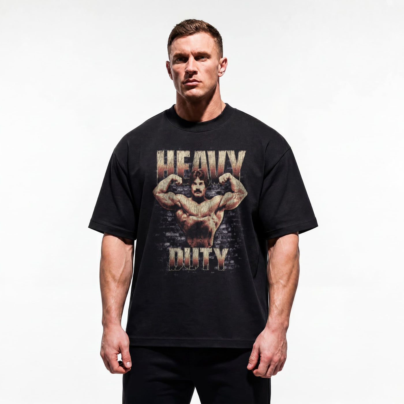 Model wearing Mike Mentzer Heavy Duty bodybuilding oversized t-shirt showing relaxed drop-shoulder fit