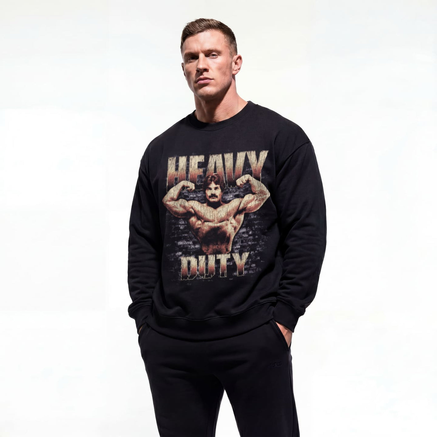 Model wearing Mike Mentzer Heavy Duty bodybuilding pump cover crewneck showing front graphic print
