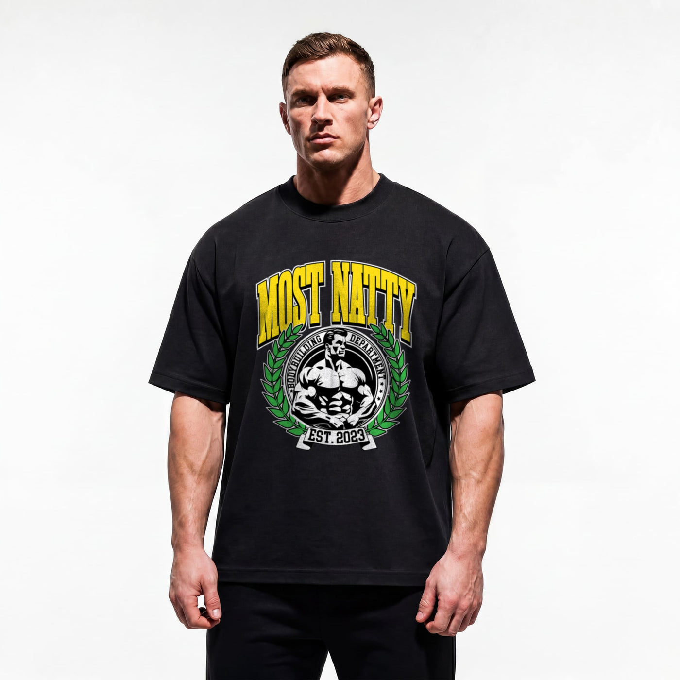 Model wearing Most Natty Most Natty College bodybuilding oversized t-shirt showing relaxed drop-shoulder fit