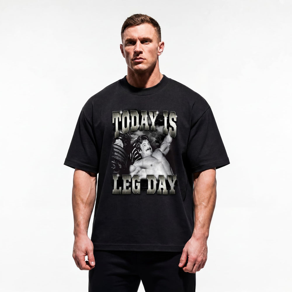 Model wearing Mike Mentzer Today Is Leg Day bodybuilding oversized t-shirt showing relaxed drop-shoulder fit