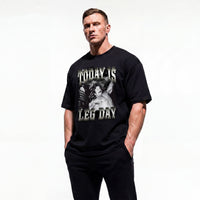 Model wearing Mike Mentzer Today Is Leg Day bodybuilding oversized t-shirt showing front graphic print