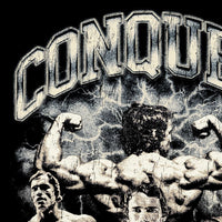 Close-up detail of Arnold Schwarzenegger Conquer vintage tribute design with cracked and worn texture treatment showing cracked vintage print texture
