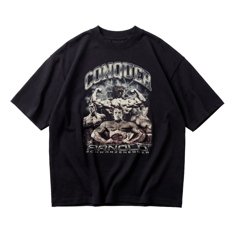 Most Natty Conquer oversized gym t-shirt featuring Arnold Schwarzenegger, front flat lay on white background