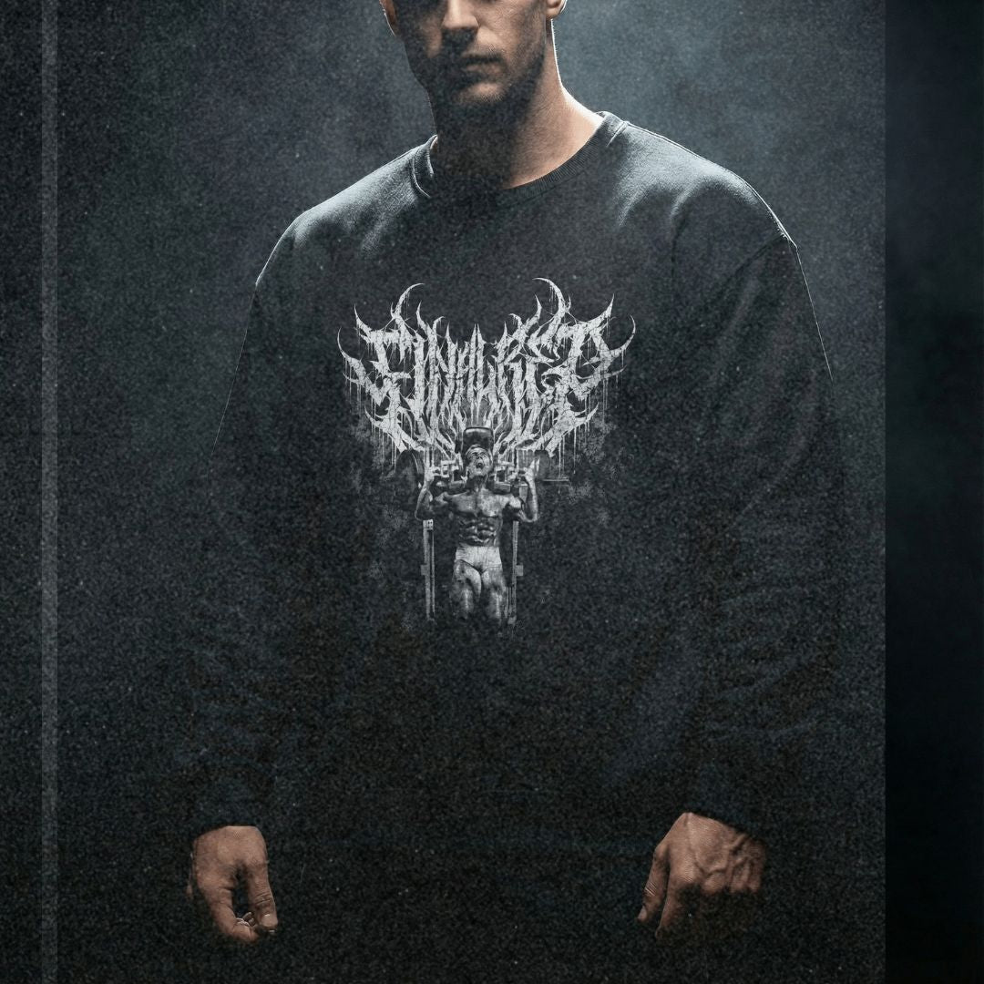 Model wearing Tom Platz Final Rep bodybuilding pump cover crewneck in dark moody gym setting with dramatic lighting