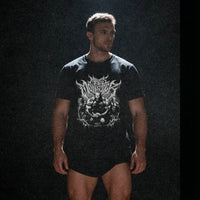 Model wearing Most Natty Mass Monster bodybuilding t-shirt showing relaxed classic fit in a moody setting