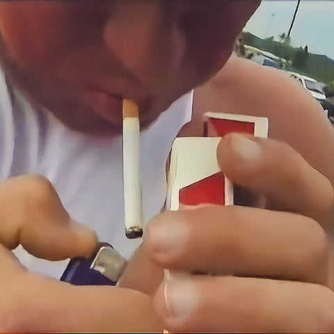 Video for Markus ruhl smoking a cigarette and lifting heavy tank top.